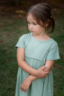 Pensive Girl with Arms Crossed